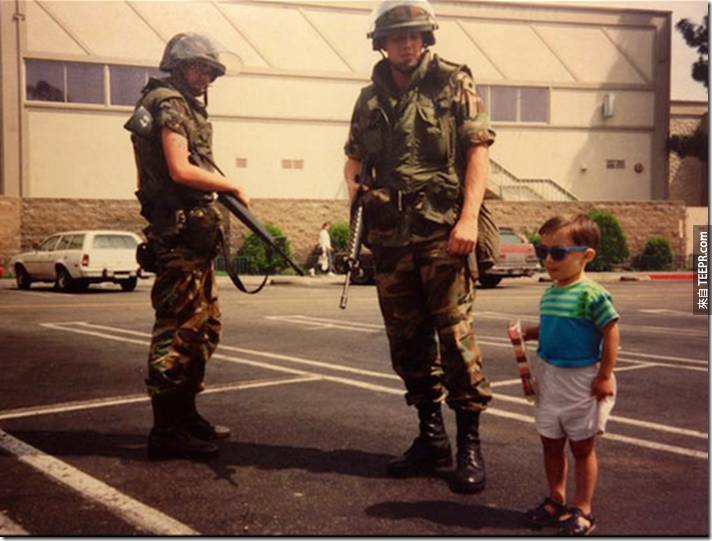 一名小朋友在一些国民警卫队成员旁边拍照 (洛杉矶，美国 1992)