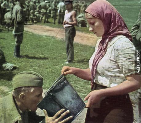 一個蘇聯士兵被捕後，一位烏克蘭女子給她水喝。(1941年)