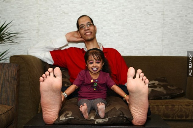 她跟全世界腳最大的男人合照。