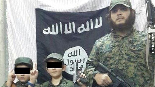 Sharrouf  (右邊) 已經收到澳洲的逮捕令， 他在最近也發佈了他和他的小孩拿著槍支的畫面在伊斯蘭激進組織 ISIL 的旗幟前。 