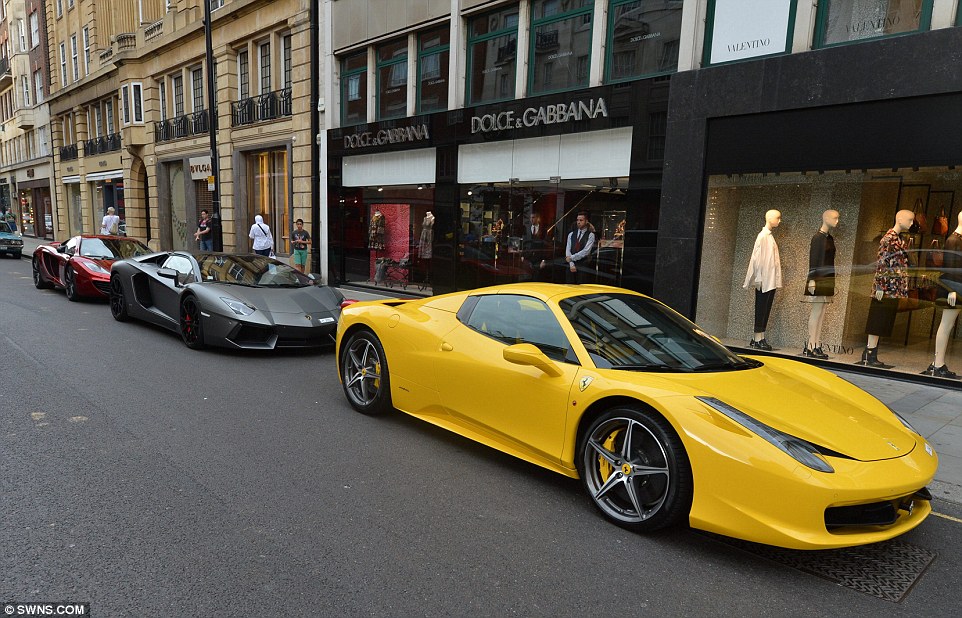 A Qatari-owned £200,000 Ferrari 458 in front of a £300,000 Lamborghini Aventador. The cars attracted gangs of camera-wielding youths, dubbed the 'Carparazzi' in Knightsbridge this summer 