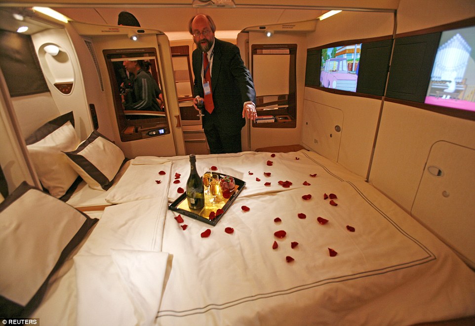1st place: a guest of Singapore Airlines inspects a double bed in a first class suite on an Airbus A380. They serve 2004 Dom Pérignon champagne