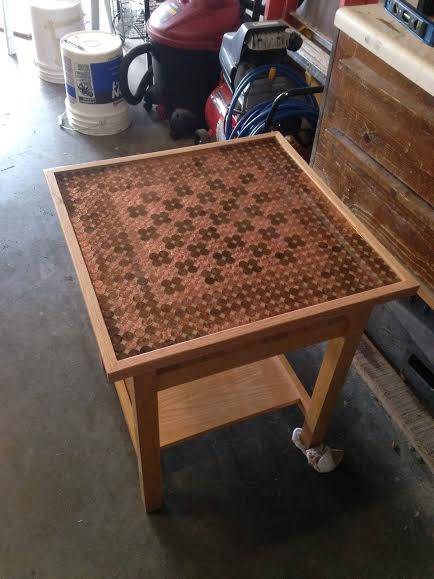 Once the pennies were arranged to create a chess board, epoxy was used to seal them to the surface. There you have it - a penny chess table.