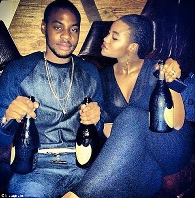Thirsty? Seeing in 2015 with a beverage, this man clutches two bottles of champagne as a friend holds her own