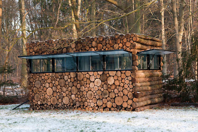 <p>Wrong! This little studio simply has a log facade. The images of logs are even screened onto the windows so it completely blends in when they're closed. When opened up, the house is more obvious, but it's still pretty low profile. </p>