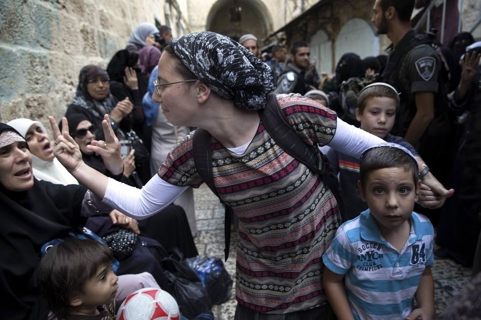 11. 在一場反對猶太人到訪耶路撒冷舊城的抗議當中，一位伊斯蘭女子和巴基斯坦女子正互相比出無禮的手勢。