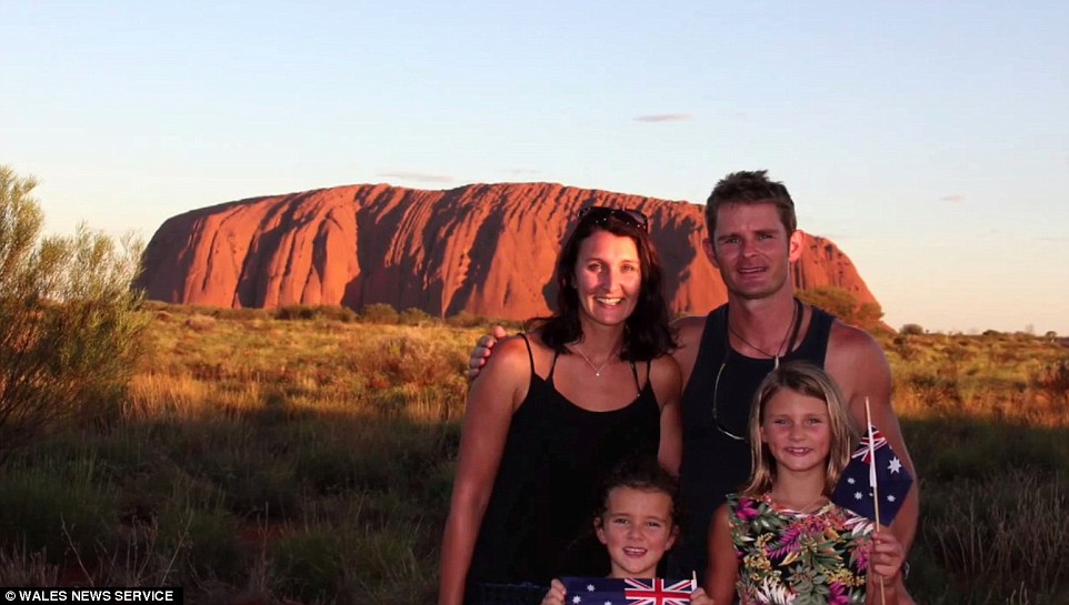 The parents home schooled their daughters as they visited 12 countries, pictured at Ayers Rock, also known as Uluru, in central Australia