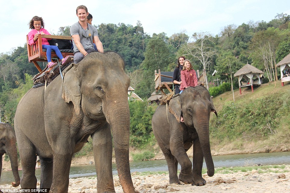 The children were taught the national curriculum throughout the trip, pictured riding elephants in Luang Prabang, Laos