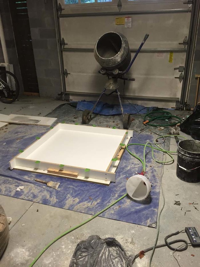 He used a spray gun to distribute the concrete into the mold. He sprayed it up the sides so the tabletop was hollow.