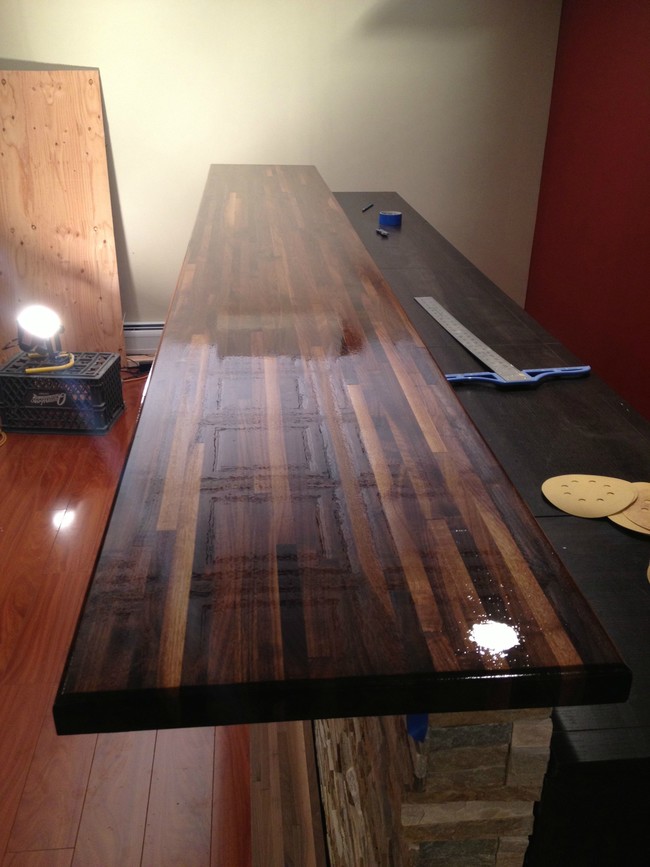 A large walnut butcher block finished with water sealant and high gloss resin would act as the bar surface.