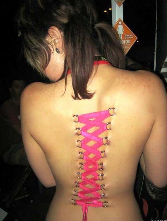 Corset piercing on this woman's back.