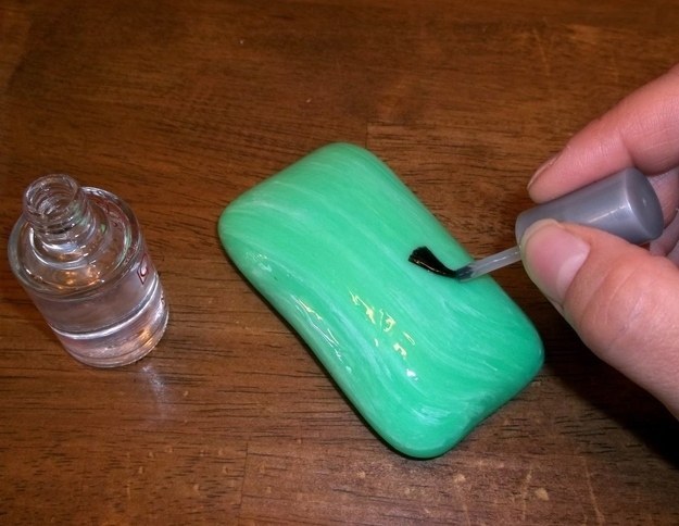 Paint a bar of soap with finger nail polish and leave it in the shower.