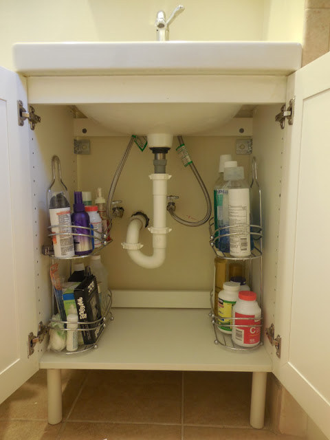Move the shower caddies under the sink for storage that will actually stay de-cluttered.