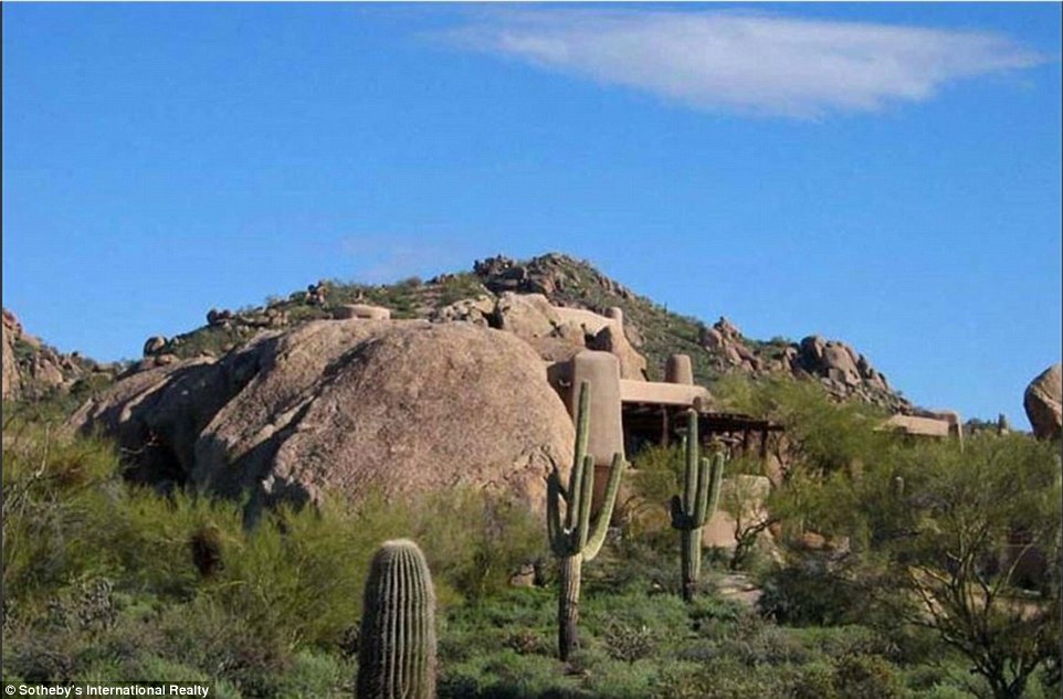 From some angles, it almost looks as if there is no home sitting on the plot of land. At a closer look however, walls of stucco and wood can be seen hidden behind the cacti