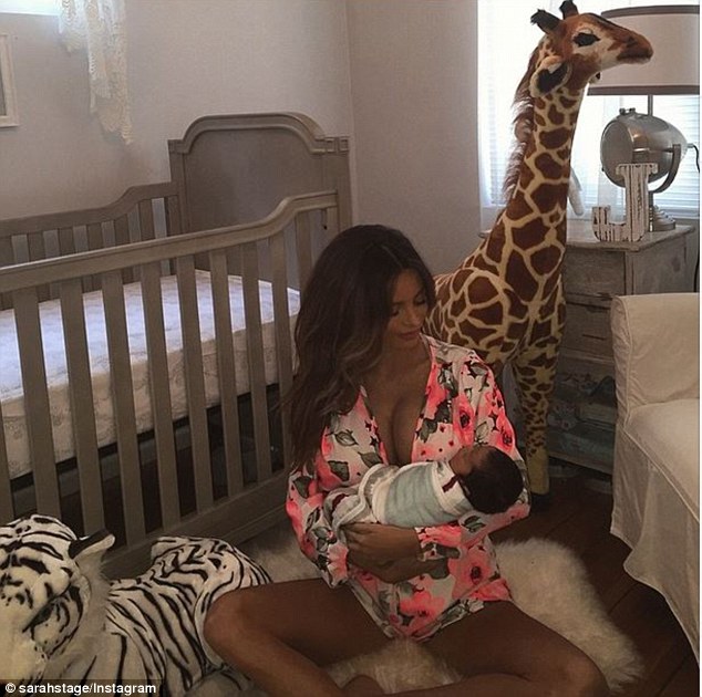 Look of love: Sarah gazed adoringly at her newborn son in this photo she posted on Saturday
