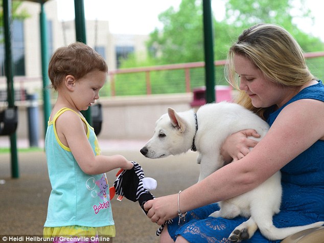 Playing and learning: 'In the future, I could see Sapphyre at her first show-and-tell in school and she could bring in her dog and explain about her dog and herself,' said an employee at Shriners Hospital 