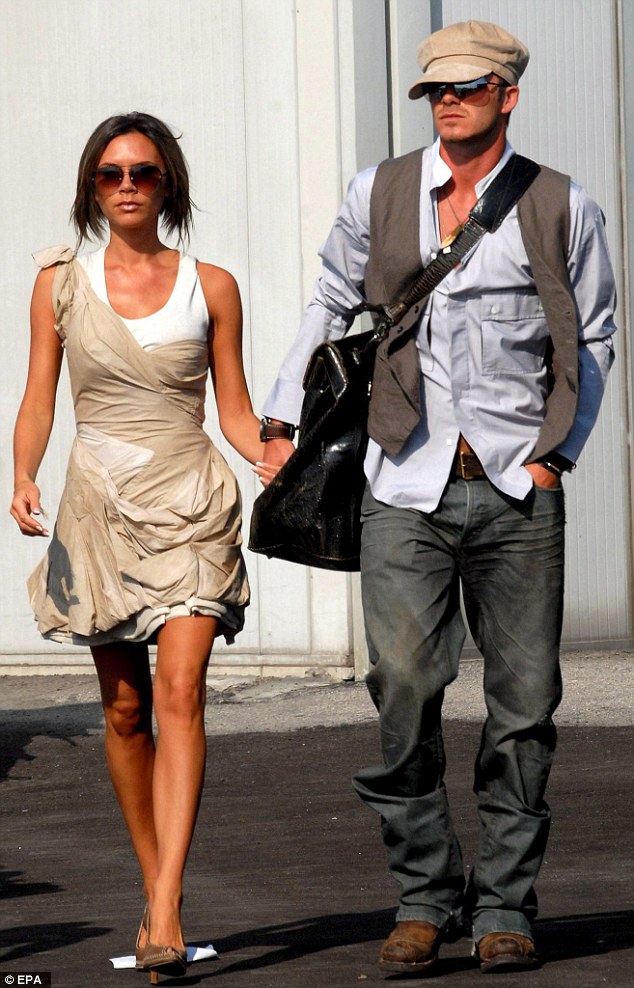 David channels a paper boy as he and Victoria  arrive at Venice's Marco Polo international airport in 2006