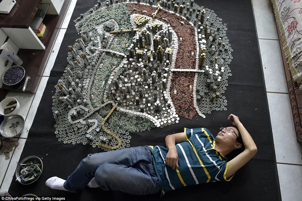 Well-earned rest: He Peiqi (pictured) spent a month piling up both ancient and modern coins from 11 different currencies to make a model of Chongqing City