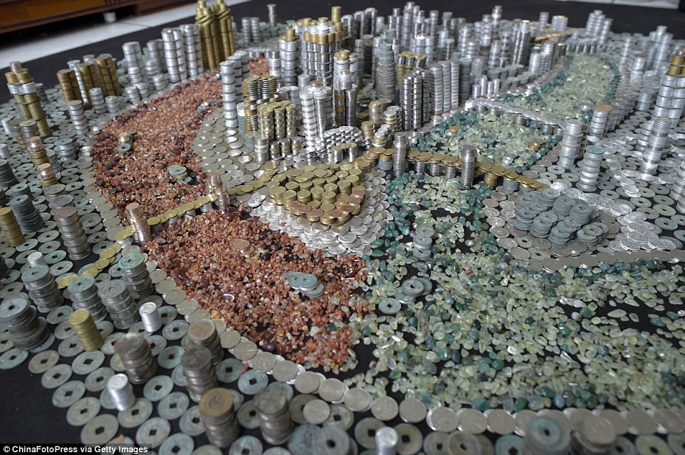 Stacks of cash: A Chinese man has created a spectacular model of his hometown - Southwest China's Chongqing City - using 50,000 coins