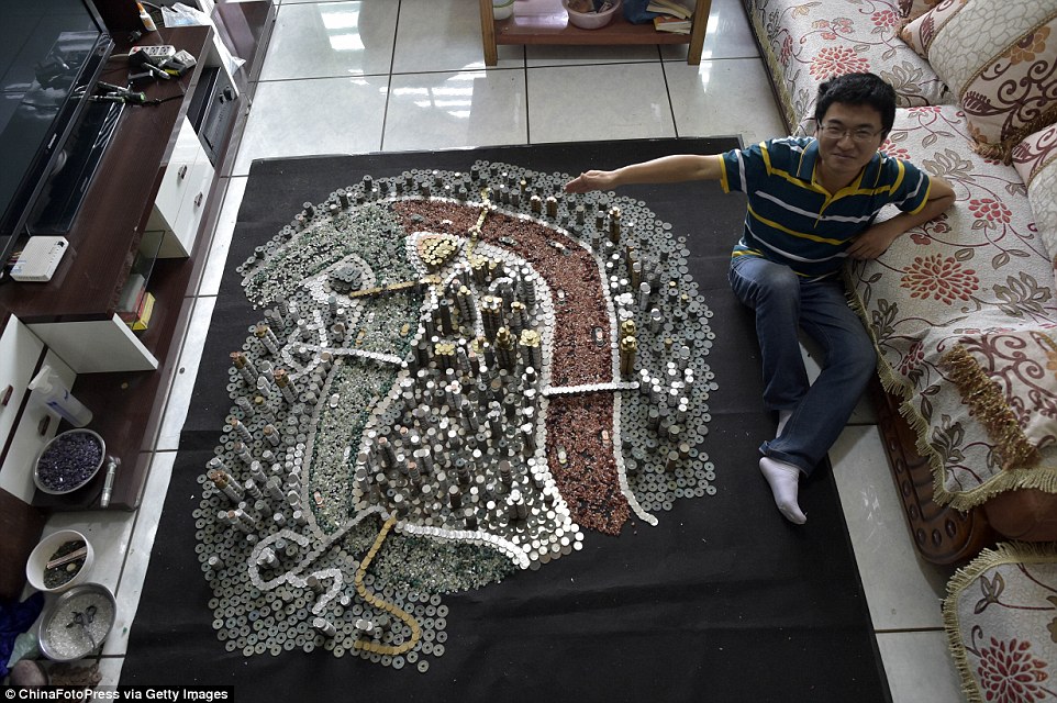 A job well done: The coin art lover shows off his masterpiece at his home in the Yongchuan District of Chongqing, Southwest China