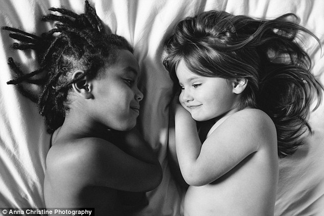 Barely different: Anna Christine in her photo series Barely Different takes photos of one of her biological daughter Haven (right) in loving scenarios with her adopted daughter Semenesh (left) from Ethiopia