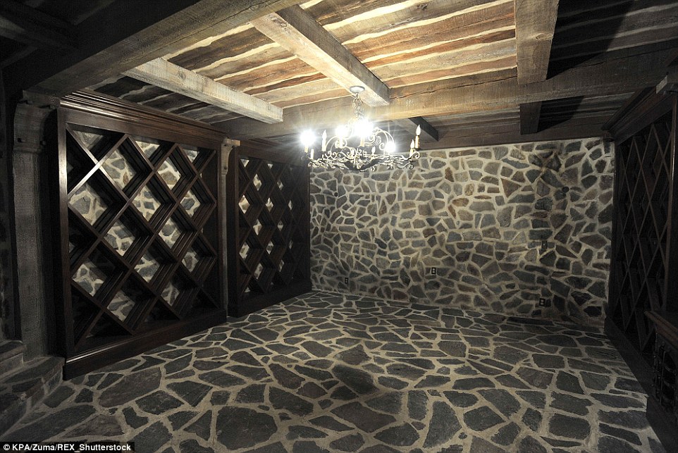 Mysterious: A wine cellar below the arcade (pictured 2009) features stone walls and flooring and dark wood shelving 