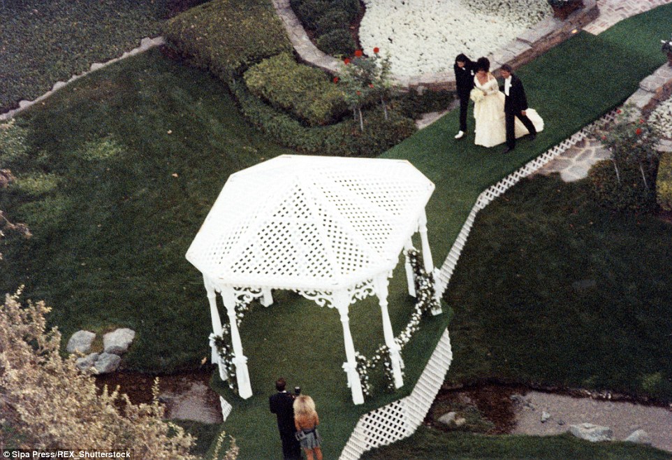 Wedding bells: Elizabeth Taylor was escorted by Jackson and her son Michael Wilding Jr. to the gazebo where she married Larry Fortensky, her eighth and final husband, in 1991 