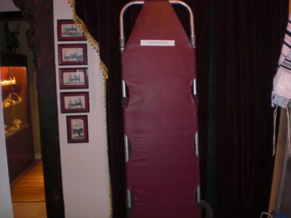 The museum is populated with instruments and symbols of death, like this stretcher.