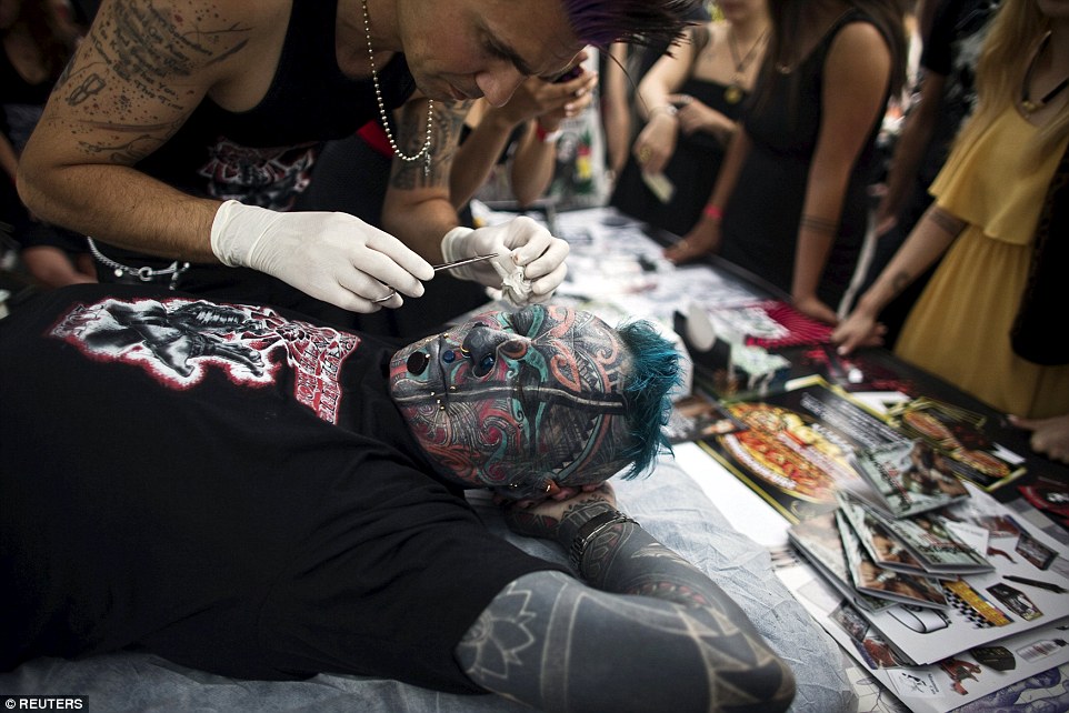 Just a little bit more: Magneto, a German tattoo model, has piercings added just underneath each eye at the Tel Aviv tattoo convention