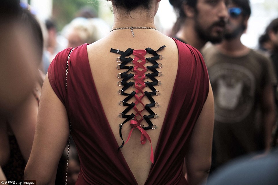 Delicate: A woman displays her novel piercings at the event, which feature a series of metal loops with silk thread woven between them