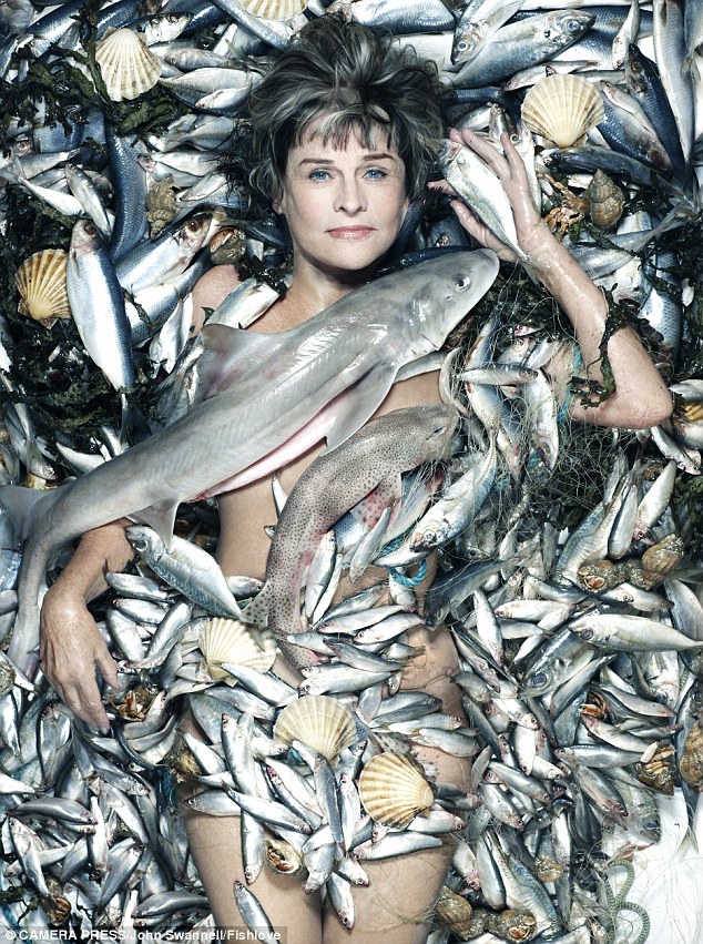 Veteran star Julie Christie is shown lying on a bed of fish shells and seaweed