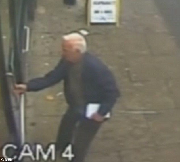Mr Smith peered  inside the shop and held the door shut after seeing the robbery taking place