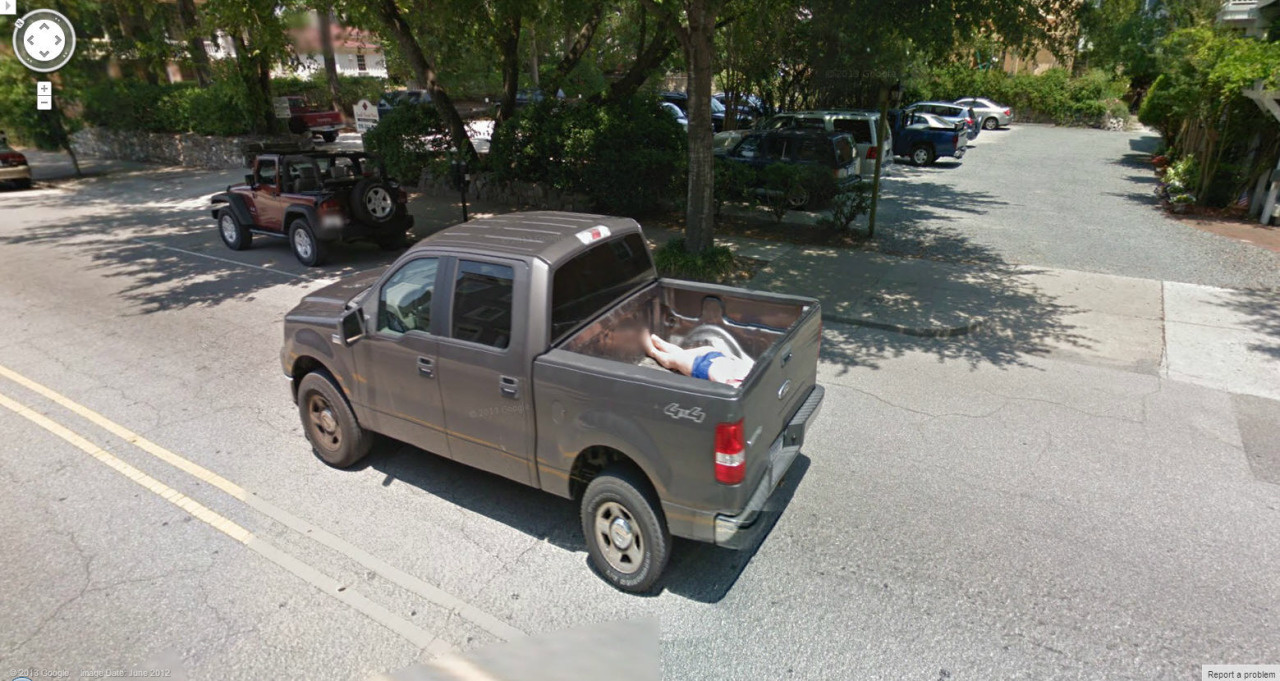 What looks like a dead body in the back of a pickup truck.
