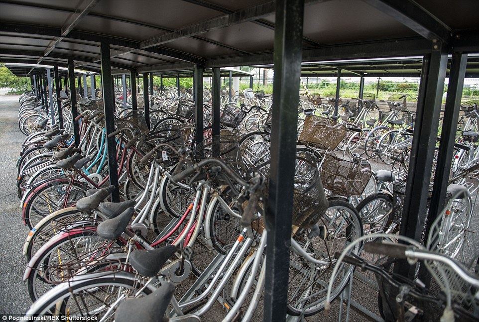 Dozens of abandoned bikes lie chained to bike rails. They are among the network of towns and villages near the power plant that were populated prior to the disaster