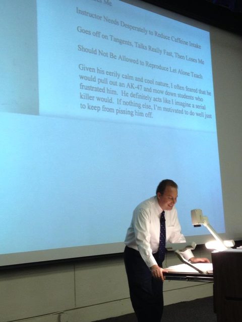 University professor reading his own teaching reviews to the class.