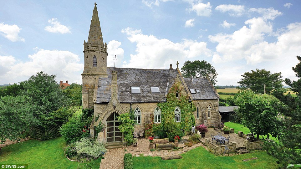 Impressive property: Old Church House has been careful restored to keep the original stained glass, windows, church tower and even the altar