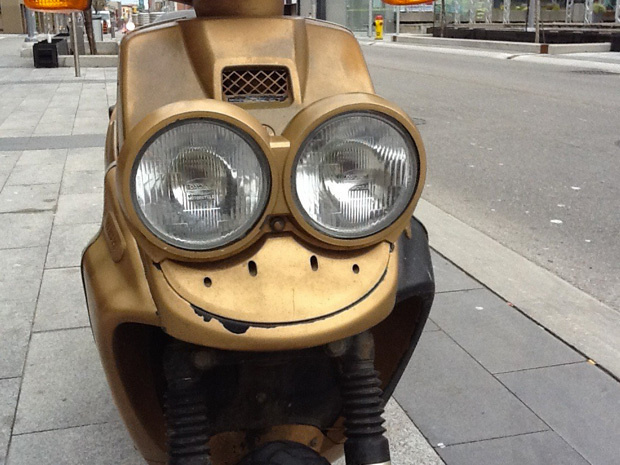 A tiny moped that could not be happier.