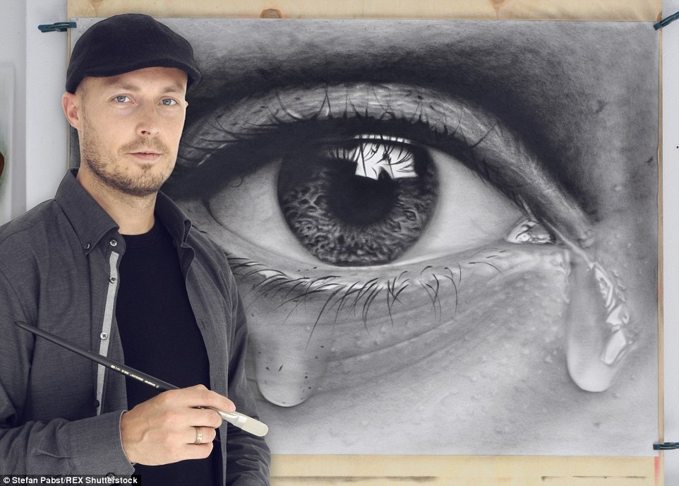 Unique view: Mr Pabst poses next to one of his pictures, using both the photorealistic style he has adopted for portraits and the 3D technique he has perfected to create the tears