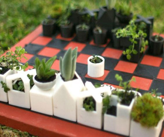 A chess set made of succulent planters.