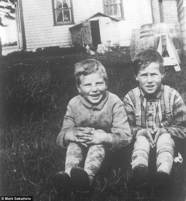 Ralph MacLean (right) pictured outside his family home in the Magdalen Islands in 1924