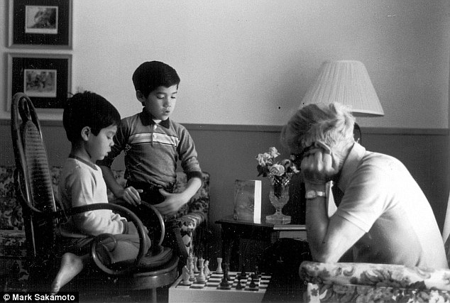 Ralph playing chess with his grandsons Daniel and Mark Sakamoto in 1985