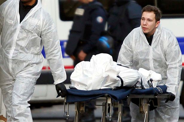 A victim is wheeled out of the Bataclan concert hall the morning after a series of deadly attacks in Paris, November 14, 2015.