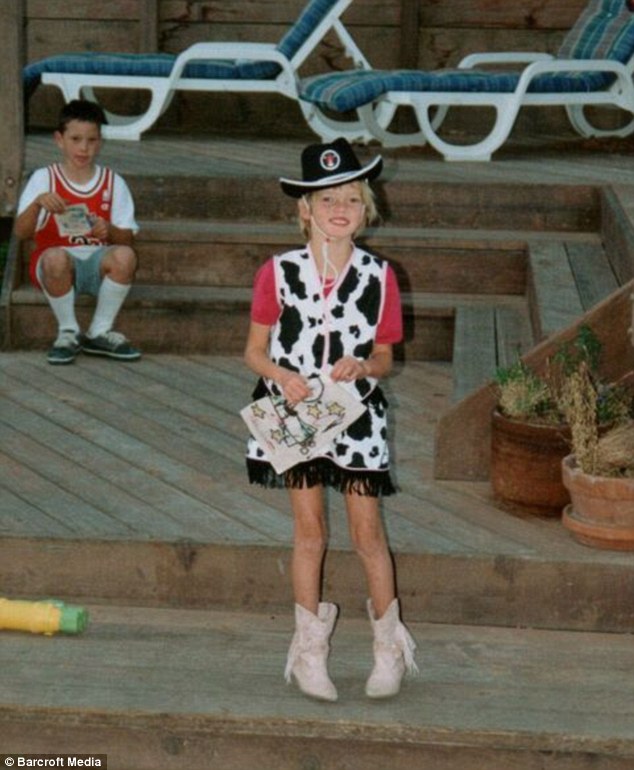 All dressed up: A young Chase can be seen wearing a cowgirl outfit in her backyard