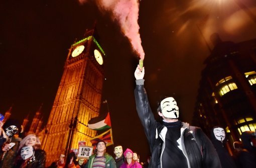 Protestors demonstrate near the Houses of Parliament in London, during the Million Mask March bonfire night protest organised by activist group Anonymous.