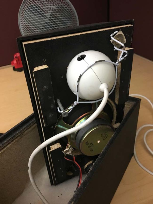 After removing the back, he found this. That white thing is not a speaker -- it's actually a web cam. Someone created this unique spy speaker with bad intentions.