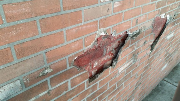 This real brick that someone covered with fake brick.