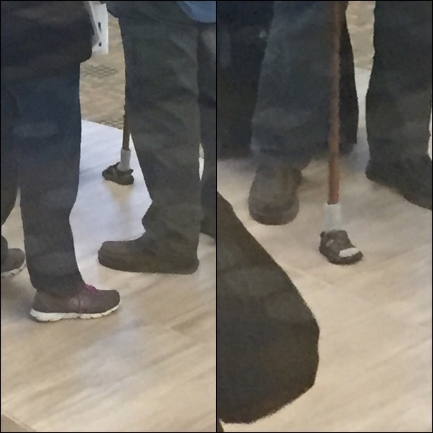 This man's walking stick that is wearing a little shoe.