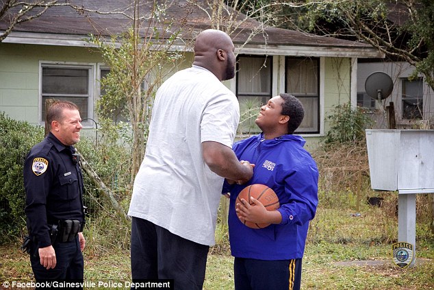 The kids - as well as Officer White (left) were in awe that Shaq would join them on their neighborhood court 