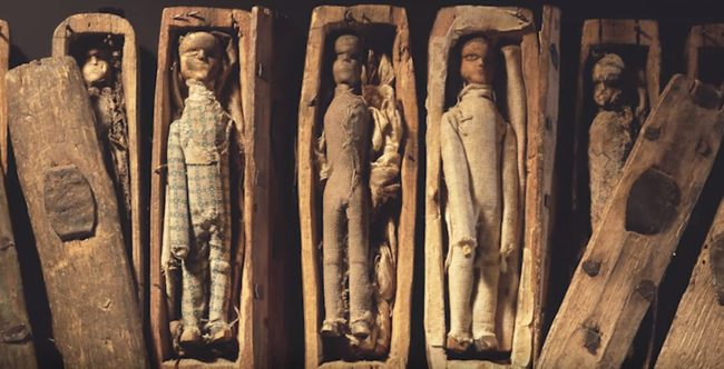 Hidden away in a small cave, the boys discovered 17 miniature coffins, each containing a small wooden figure.