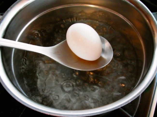 The chef recommends adding some salt to the water. When it reaches a rolling boil, put your eggs in.
